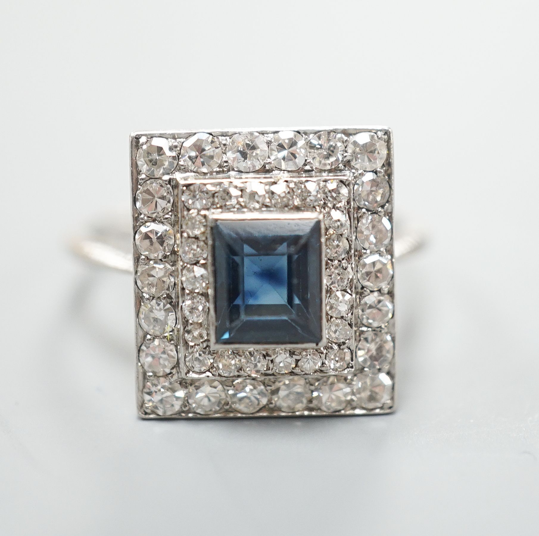 A white metal, sapphire and diamond set square cluster ring, size N, gross weight 4.2 grams.